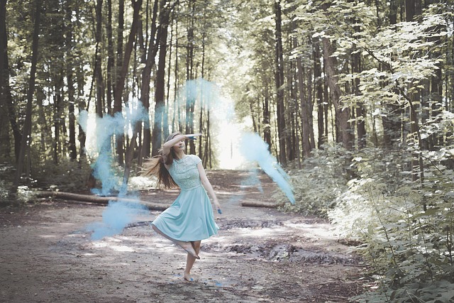 two neighbours having a friendly conversation over a garden fence on a sunny day in a suburban neighbourhood
